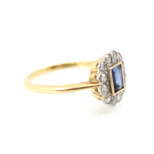 241 - An early 20th century untested sapphire and diamond cluster ring, the rectangular cut sapphire in ye... 