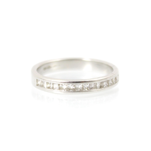 248 - A diamond half eternity ring, the fourteen square cut diamonds channel set within white metal band, ... 