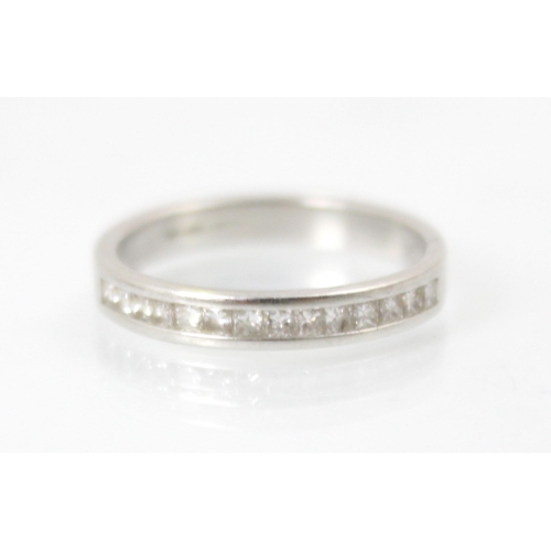 248 - A diamond half eternity ring, the fourteen square cut diamonds channel set within white metal band, ... 