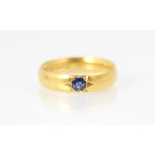 250 - A 22ct yellow gold wedding band, with a round cut untested sapphire later set into the band, ring si... 