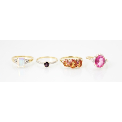 251 - A selection of four dress rings, including a yellow metal colour change sapphire and diamond ring, r... 