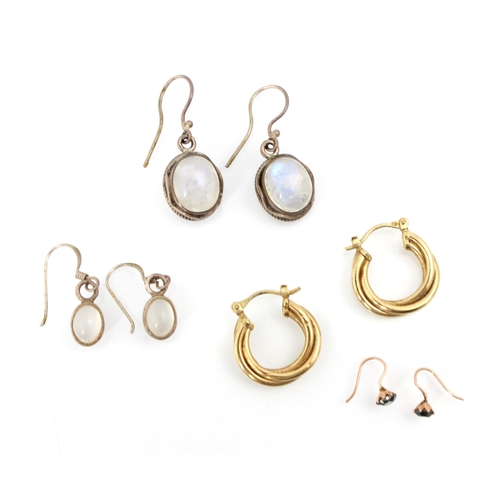 264 - A selection of earrings, including a pair of quartz cats eye style earrings, the cabochons set withi... 