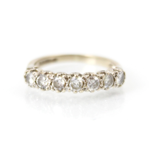 273 - A late 20th century 18ct white gold diamond half eternity ring, the seven round cut diamonds within ... 