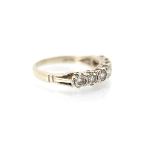 273 - A late 20th century 18ct white gold diamond half eternity ring, the seven round cut diamonds within ... 