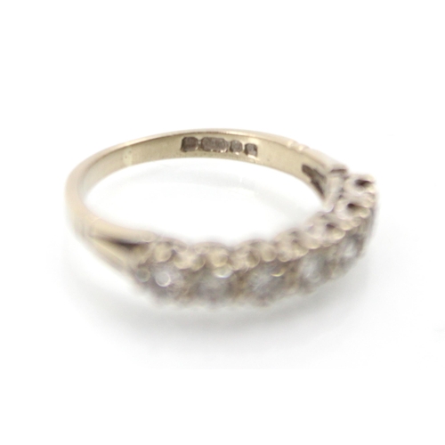 273 - A late 20th century 18ct white gold diamond half eternity ring, the seven round cut diamonds within ... 