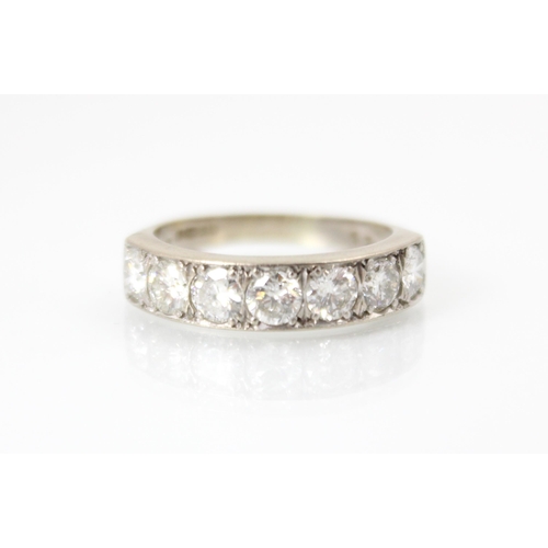 277 - An 18ct white gold diamond ring, the seven round cut diamonds within claw setting edge, upon plain p... 