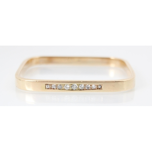 280 - A bespoke yellow metal diamond bangle, the rectangular bangle with nine graduated diamonds set withi... 