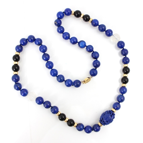 304 - A lapis lazuli and rock crystal necklace, the spherical lapis lazuli beads interspersed with black s... 