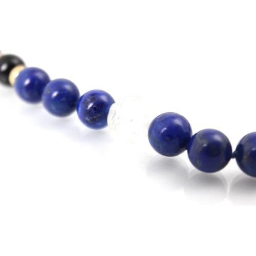 304 - A lapis lazuli and rock crystal necklace, the spherical lapis lazuli beads interspersed with black s... 