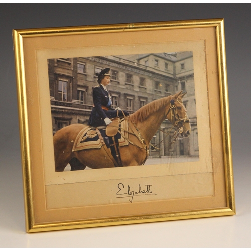 320 - QUEEN ELIZABETH II INTEREST: A printed photograph of Princess Elizabeth mounted side saddle on a hor... 