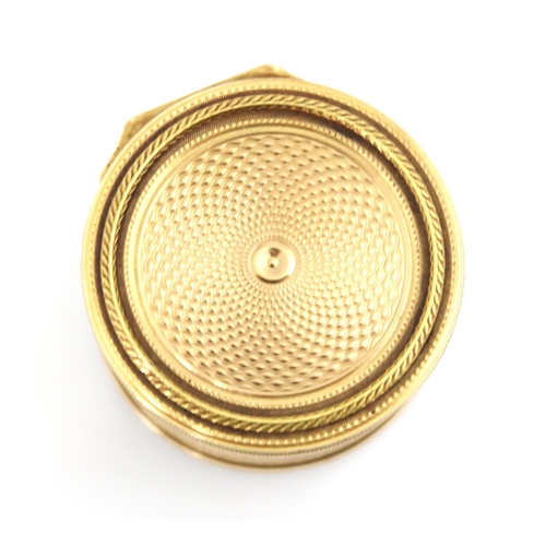 321 - A 20th century gold coloured vinaigrette, the circular hinged cover with concentric engine turned de... 