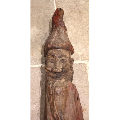 379 - An 18th/19th century carved pine and polychrome continental figure of a double sided gnome, modelled... 