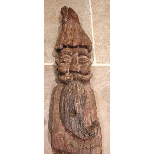 379 - An 18th/19th century carved pine and polychrome continental figure of a double sided gnome, modelled... 