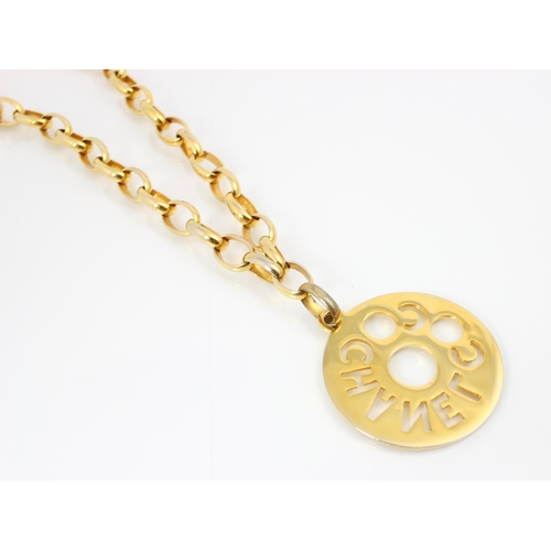 427 - A Coco Chanel gold coloured pendant and chain, the circular pendant of medallion style with openwork... 