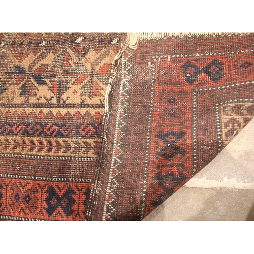 943 - A Caucasian wool rug, in red, blue and brown colourways, the central field with rows of stylised lea... 