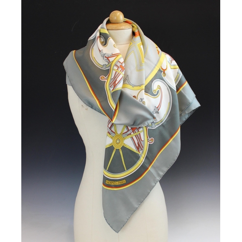 432 - An Hermes silk scarf, in the 'Washington's Carriage' pattern, in grey, orange and yellow tones, with... 