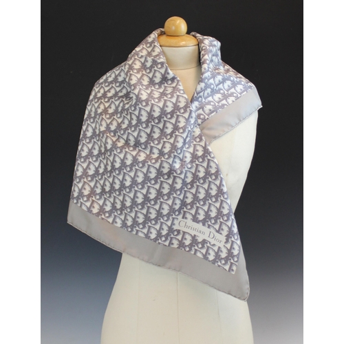 434 - A Christian Dior silk scarf, in grey monogram within a grey border, with rolled hem, 77cm x 77cm, un... 