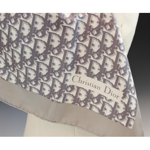 434 - A Christian Dior silk scarf, in grey monogram within a grey border, with rolled hem, 77cm x 77cm, un... 