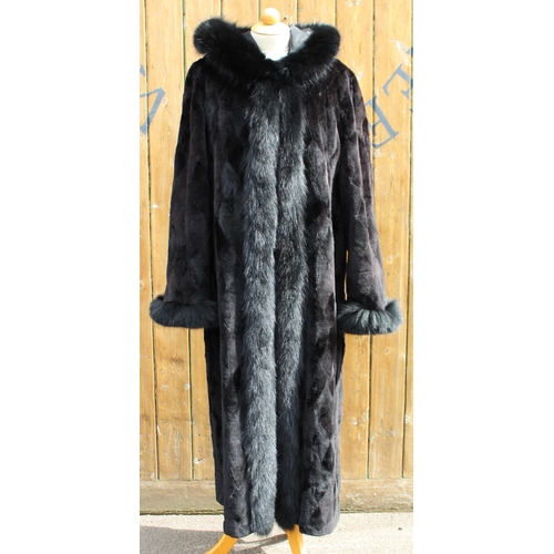 412 - A ladies hooded and reversible mink fur winter long coat, late 20th century, with black fox fur trim... 