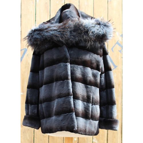 417 - A ladies hooded and reversible mink and Finn Racoon fur winter jacket, late 20th century, with Racoo... 