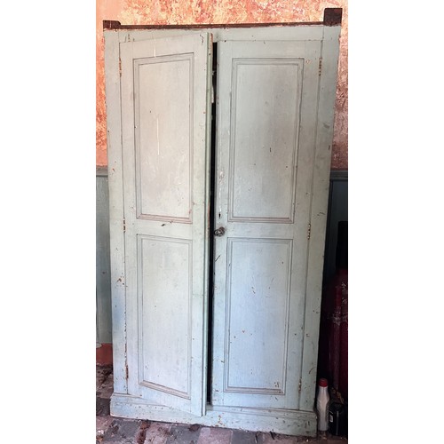 1056 - A Victorian painted pine kitchen cupboard, the twin panelled doors opening to four fixed shelves, up... 