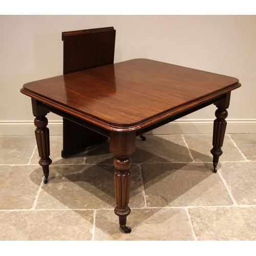 1066 - A Victorian mahogany extending dining table, the rectangular top with rounded corners, upon tapering... 