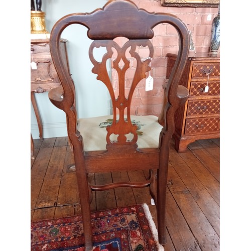 1008 - A George II style walnut elbow chair, late 19th/early 20th century, the carved shell crest uniting a... 