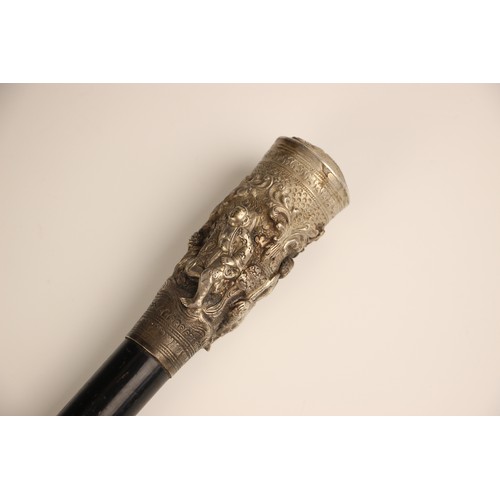 386 - A Burmese silver topped walking cane, 19th century, the tapered ebonised cane terminating with a hea... 