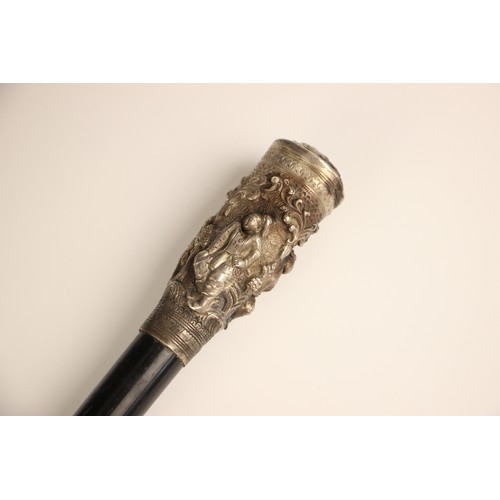 386 - A Burmese silver topped walking cane, 19th century, the tapered ebonised cane terminating with a hea... 