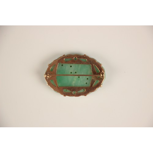 208 - A Birks Ellis ‘jade’ brooch, the carved oval panel with scalloped edge depicting floral detail, with... 