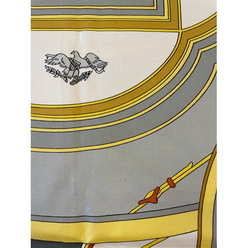 432 - An Hermes silk scarf, in the 'Washington's Carriage' pattern, in grey, orange and yellow tones, with... 