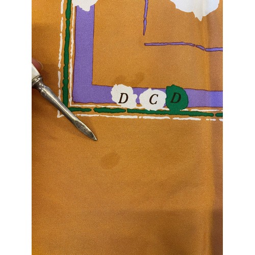 422 - A Christian Dior silk scarf, the peach scarf with green, lilac and white details, 77cm x 75cm, along... 