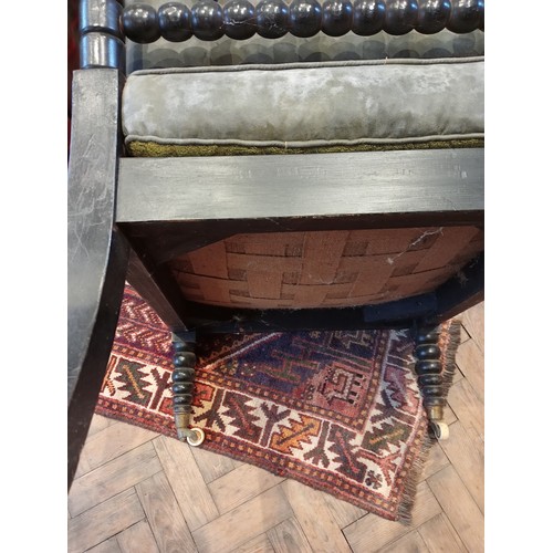 1073 - An ebonised bobbin turned open armchair, possibly walnut, mid to late 19th century, with bespoke but... 