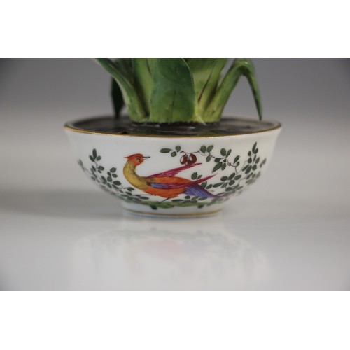 690 - A porcelain model of a hyacinth, 20th century, set to a bowl decorated with exotic birds in the mann... 