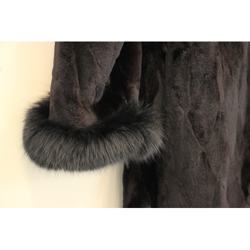 412 - A ladies hooded and reversible mink fur winter long coat, late 20th century, with black fox fur trim... 