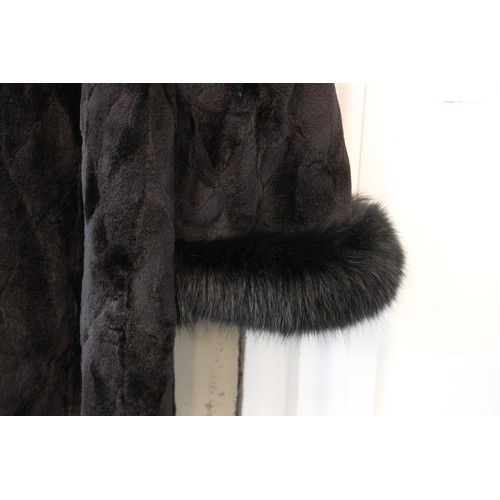 412 - A ladies hooded and reversible mink fur winter long coat, late 20th century, with black fox fur trim... 