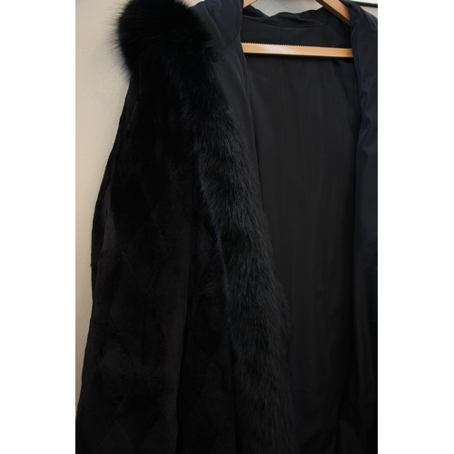 412 - A ladies hooded and reversible mink fur winter long coat, late 20th century, with black fox fur trim... 