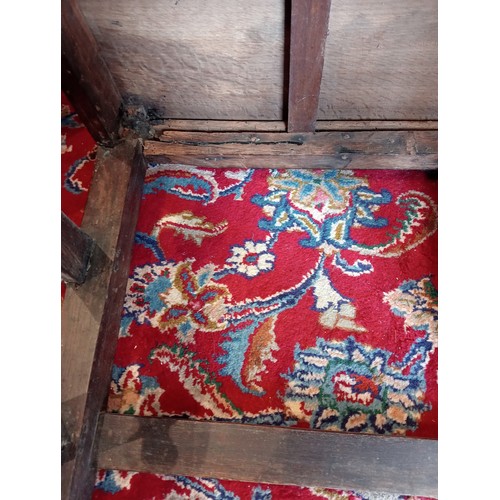 972 - A 17th century oak back stool, probably Lancashire, the three spherical finials over a scrolled cres... 