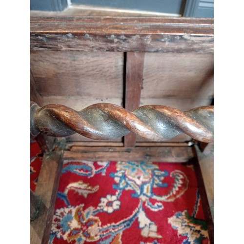 972 - A 17th century oak back stool, probably Lancashire, the three spherical finials over a scrolled cres... 