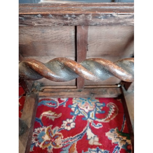 972 - A 17th century oak back stool, probably Lancashire, the three spherical finials over a scrolled cres... 