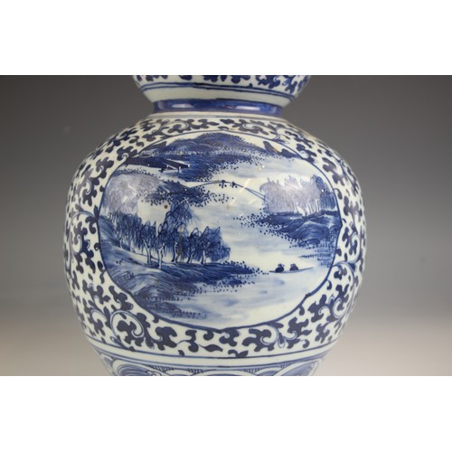 788 - A large Chinese porcelain blue and white double gourd vase, 19th century, the lower body decorated w... 