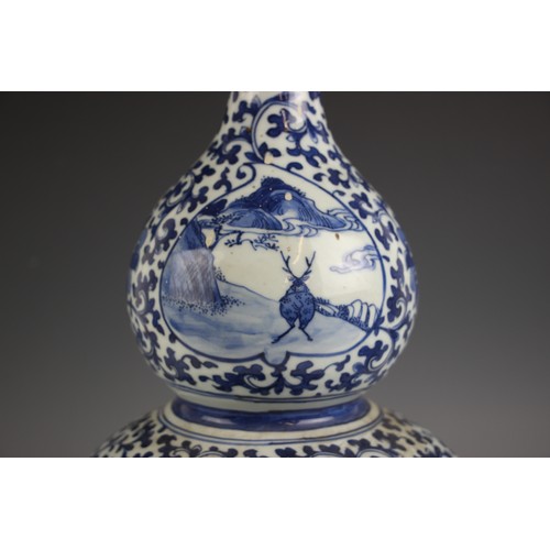 788 - A large Chinese porcelain blue and white double gourd vase, 19th century, the lower body decorated w... 