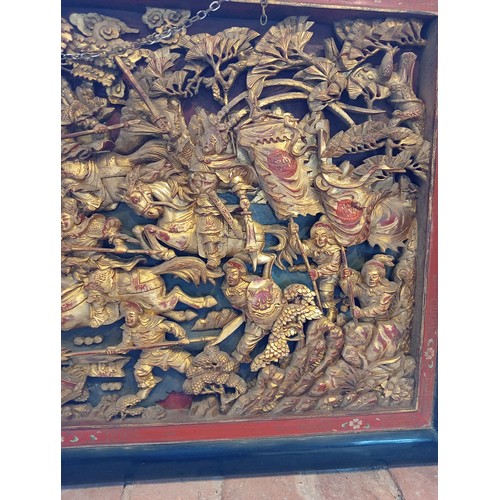 759 - A Chinese chaozhou giltwood and red lacquered carved panel, 19th century, the rectangular panel carv... 