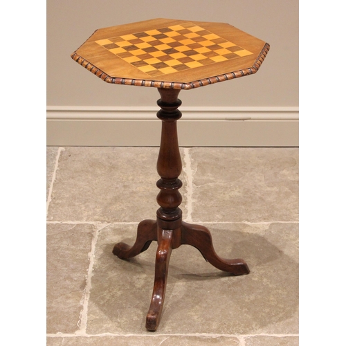 1000 - A Victorian walnut pedestal games table, the octagonal top inset with a rosewood and boxwood chess b... 