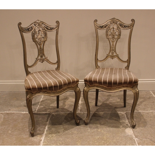 1009 - A pair of French style salon chairs, late 19th century, later painted, each with an interlaced splat... 