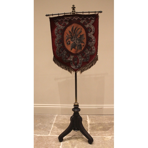 1017 - A Victorian Aesthetic Movement pole screen, the beadwork shield shaped banner, upon a brass pole ext... 