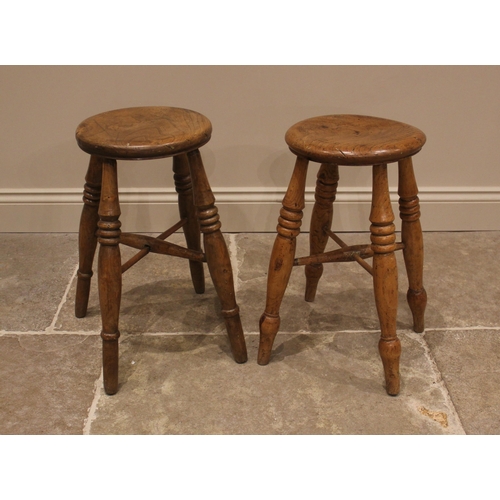 1018 - A near pair of elm Boston stools, late 19th century, the circular seats upon ring turned baluster su... 