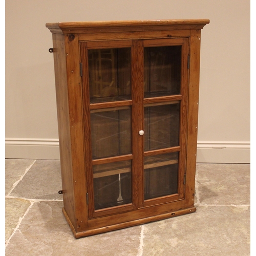 1019 - A Victorian and later, pine wall mounted display cabinet, the two glazed cupboard doors opening to t... 