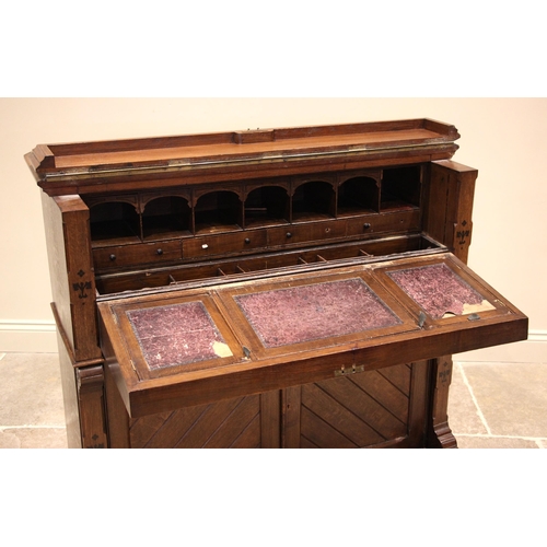 1031 - An ecclesiastical oak escritoire, late 19th/early 20th century, the rectangular moulded and hinged t... 