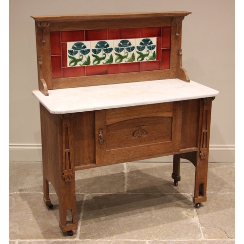 1038 - A honey oak tiled back Arts and Crafts washstand, in the manner of Liberty & Co, early 20th century,... 